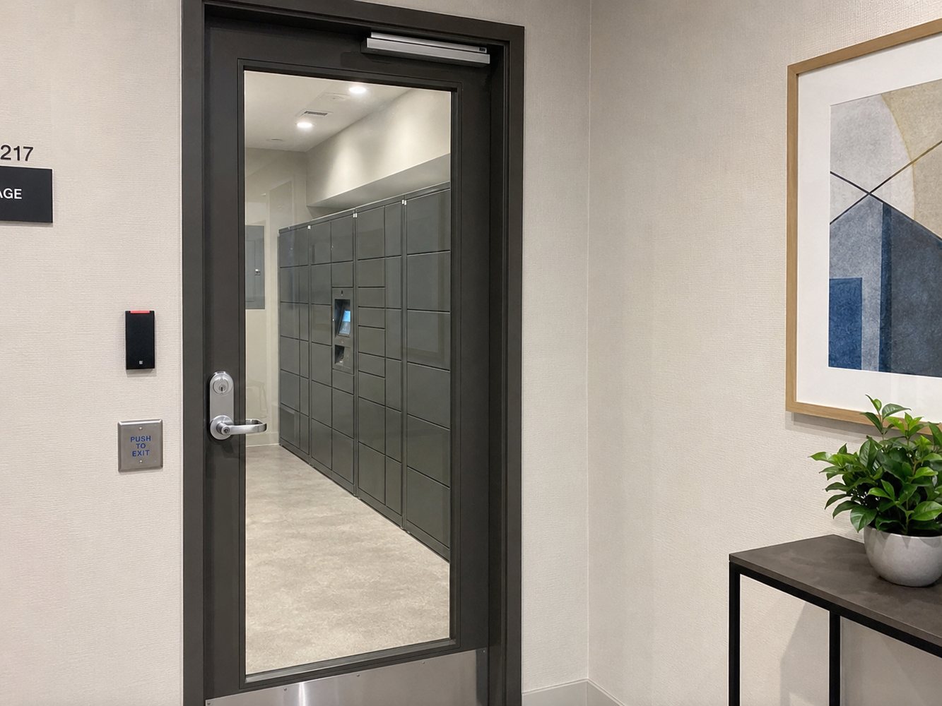 Card reader access control installed beside an apartment building package room door