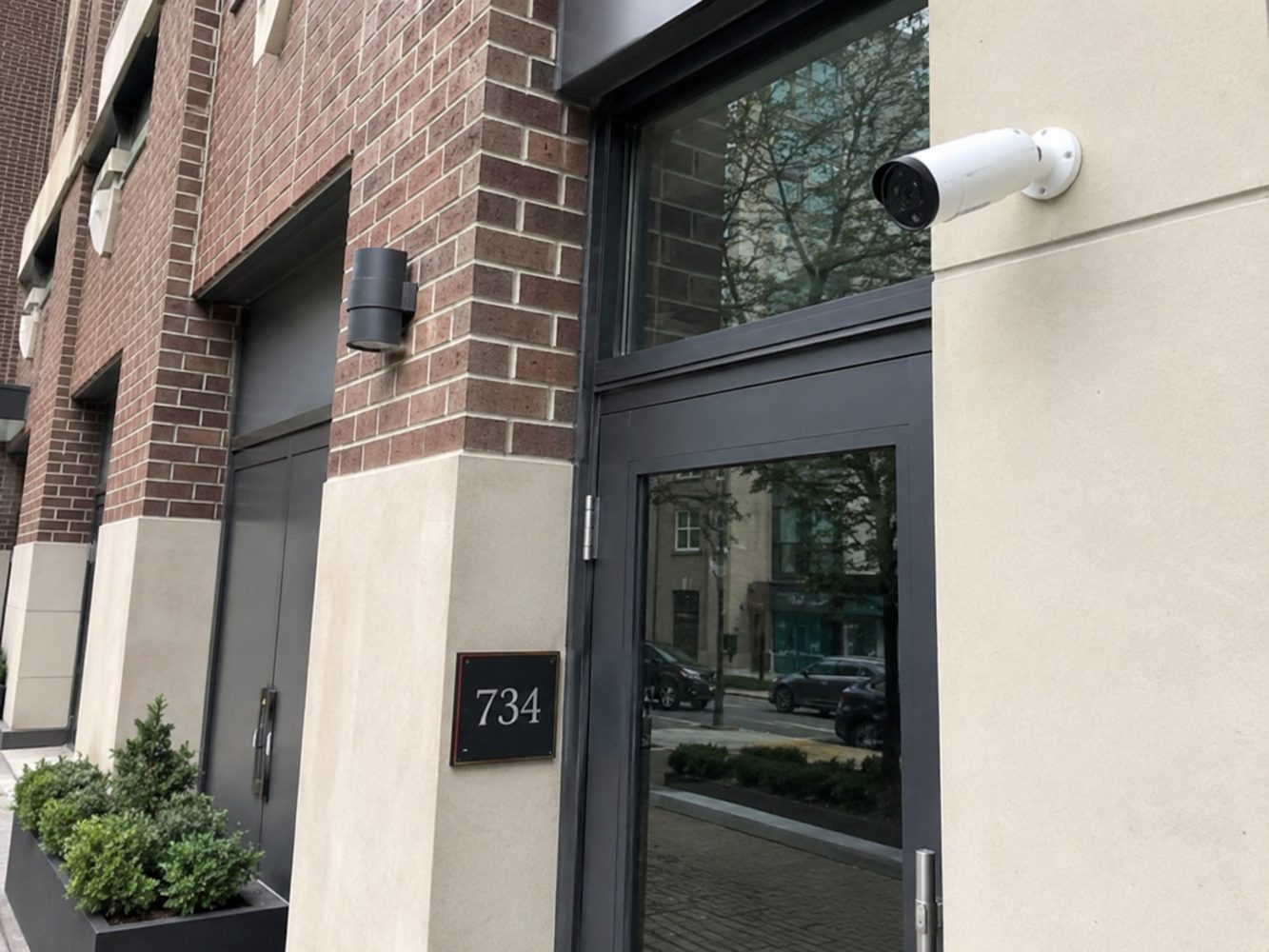 Exterior bullet security camera installed above a building entrance