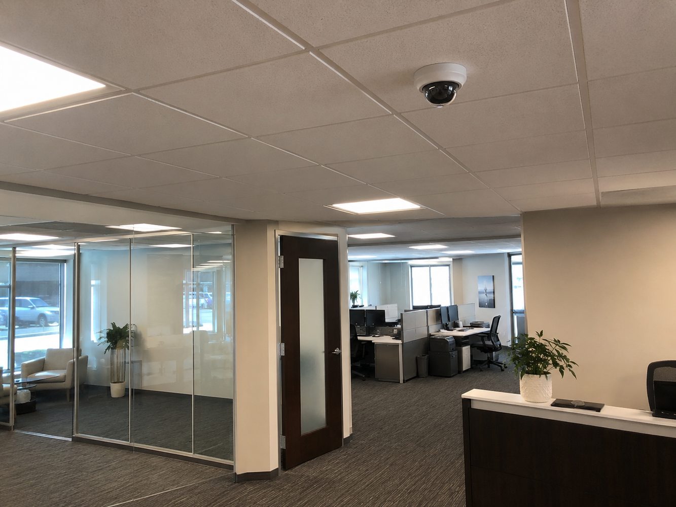 Dome security camera installed in a commercial office ceiling