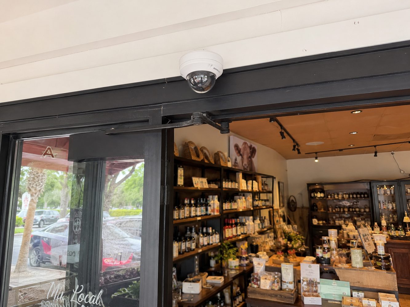 Dome CCTV camera installed above a retail storefront entrance